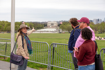 A woman pointing to the Lincoln memorial