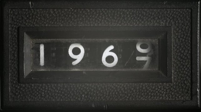 Analog counter scrolls through years 1960 to 1971, retro numeric display symbolizing time passage, history, and vintage technology.
