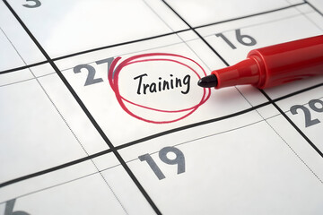 Red marker circling the word training on a calendar date