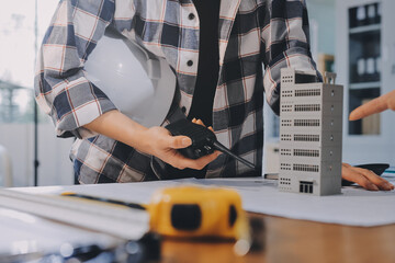 Construction and structure concept of engineer working drawing on blueprint meeting for project...