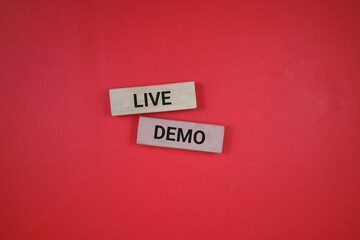 Two wooden blocks with black text spelling 'Live Demo', placed on a red background emphasizing simplicity and clarity.