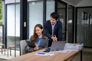 Business people working and discussing in modern office: teamwork and collaboration concept