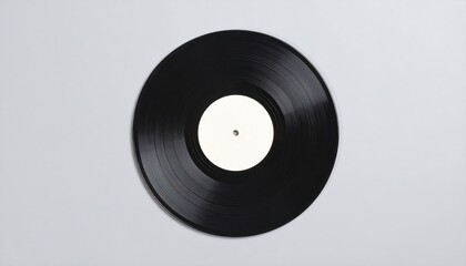 Obraz premium An overhead shot of a black vinyl record with a blank white label, set against a soft, neutral grey backdrop
