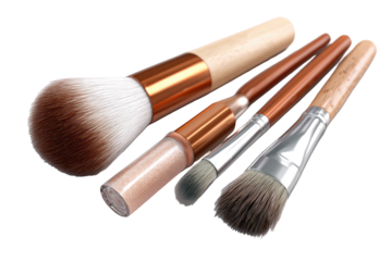 Makeup brushes in various sizes and textures, copper/tan handles