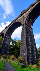 Naklejka premium Stone arch railway viaduct, low angle view