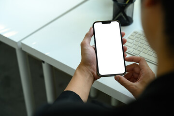 Close up of man holding a smartphone with blank white screen