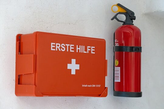 First aid box and fire extinguisher on wall