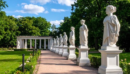 Elegant statues line a park path under a partly cloudy sky