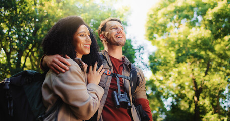 Hiking, relax and travel with couple in nature for holiday, trekking adventure and bonding. Backpacking date, environment and vacation with man and woman in forest for love, support and hobby