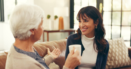 Bonding, elderly mother and daughter in home with tea, story time and catch up in conversation. Smile, communication and family in house with warm drinks, reunion and gossip in shared moment.