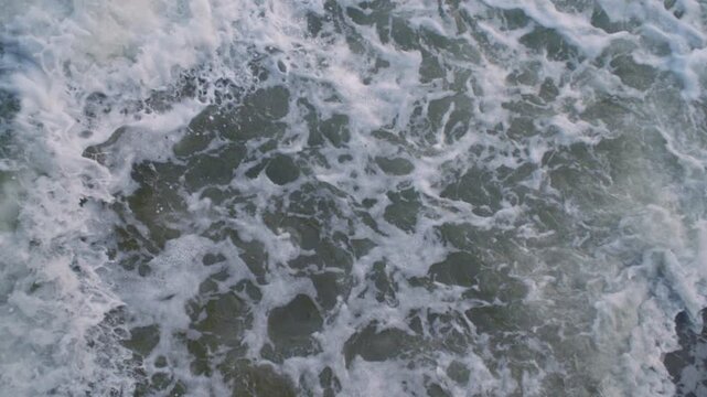 Cose-up shot of waves on the beach. Shot at Brooklyn&rsquo;s Coney Island.