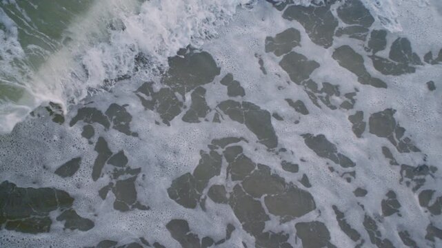 Cose-up shot of waves on the beach. Shot at Brooklyn&rsquo;s Coney Island.