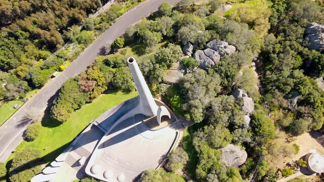 Descending drone view of historic Afrikaans language monument on Paarl Mountain