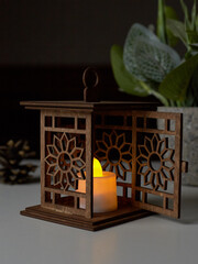 Decorative lantern with a burning candle, glowing at night