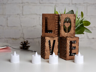 Wooden candlesticks in the form of the word Love