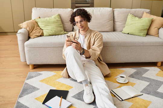 Smartly dressed young man engaged in a thoughtful moment while using his smartphone at home - Powered by Adobe