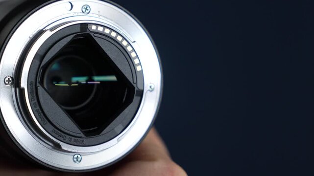 A digital close-up camera lens.
A metal bayonet mount for attaching the lens to the camera.
A modern manual lens in the hands of a photographer.