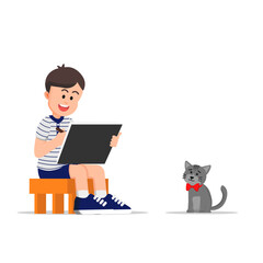 A boy sitting and drawing a cat with a bow tie