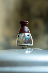 Close-up of a pressure cooker releasing hot steam through its valve, showing the process of cooking with heat and pressure in a kitchen environment