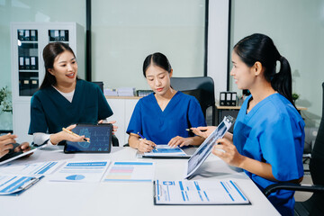 Fototapeta premium Doctors, nurses, and consultant review anatomy data on tablet and lab reports in a modern clinic. Healthtech, diagnostics, teamwork, and medical collaboration.