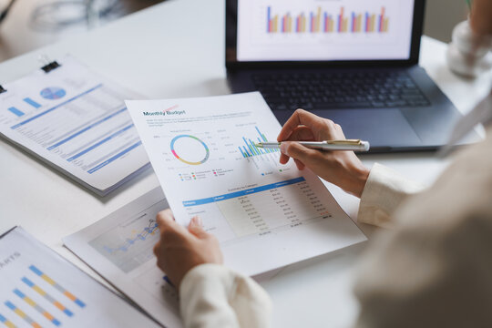 Businesswoman analyzing financial charts and graphs for monthly budget