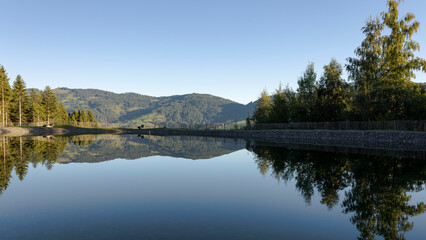 Obraz premium Calm Alpine Pond with Reflections in Tyrol, Austria