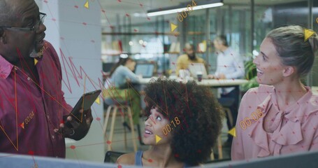 Three colleagues collaborating on data overlays in open-plan office, with tablet and laptops