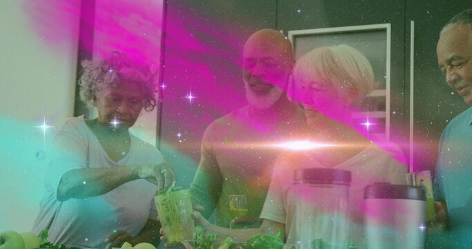 Group of friends blending and pouring fresh green smoothies at kitchen island, with juice glasses