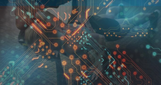 Fototapeta Performing push-up routine with exercise partners in sportswear on gym floor with circuit overlay