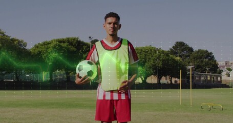 Soccer player holding ball in sports field, with fluorescent vest slalom poles hurdles and waveform