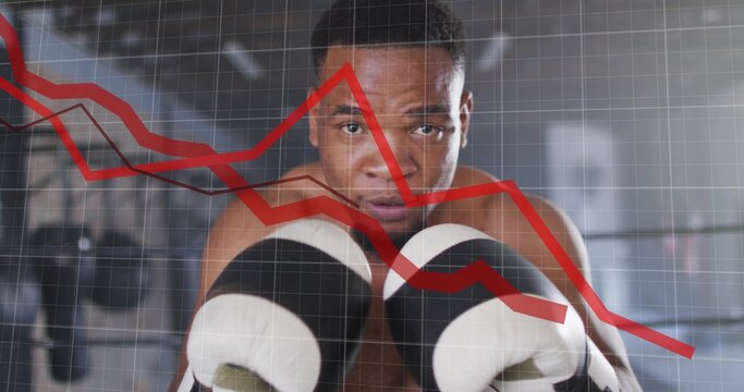 Showing shirtless boxer holding gloves in boxing gym with bags, ropes and red graph grid overlay