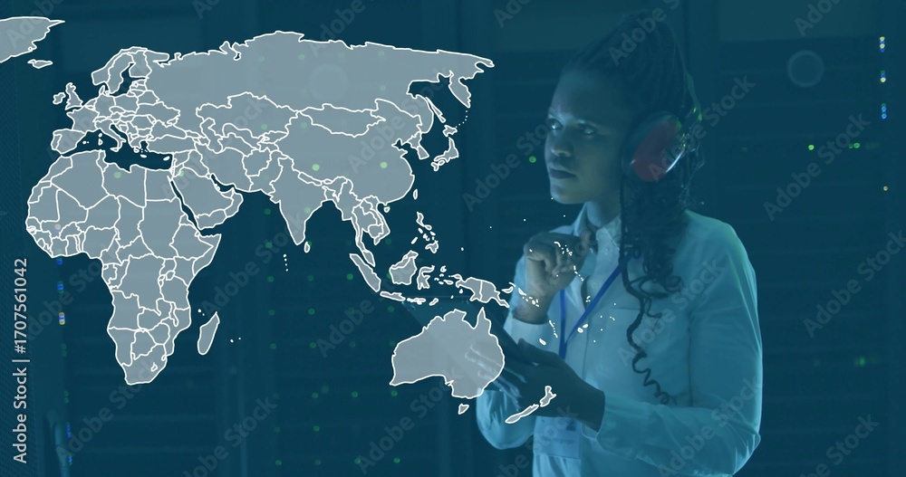 Poster operating interface engineer wearing red headset among server racks with map overlay, copy space