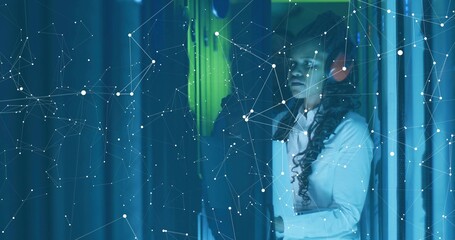 Two IT techs inspecting server racks in data center with headphones, network overlay, copy space