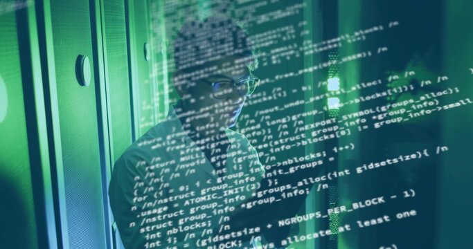 Examining Asian engineer analyzing LEDs and network cables inside data center, with green lighting