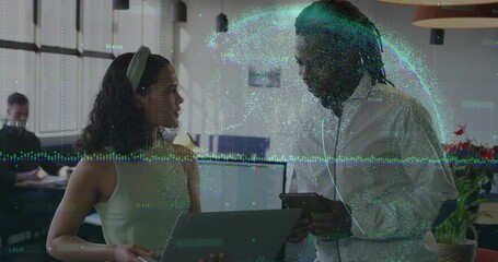 Collaborating two office professionals analyzing digital data overlay in office with laptop, tablet