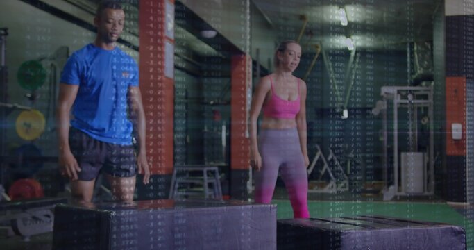 Standing fit man and woman preparing for box jumps in commercial gym, with plyometric boxes - Powered by Adobe