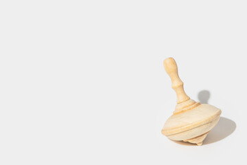 Wooden spinning top for Jewish holiday Hanukkah on white background with copy space.
