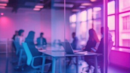Blurred office meeting background with laptop on glass table, people sitting together in purple blue tones with bokeh lights and glass wall reflections creating professional workspace atmosphere.