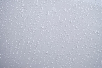 Water droplets on a white background. Raindrops on the window.