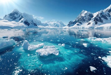 Antarctica scene showcasing a calm icy ocean reflecting snow-capped mountains against a clear, bright blue sky with floating ice formations