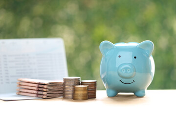 Piggy bank and banking account book on natural green background, Save money for prepare in future and pension retirement concept
