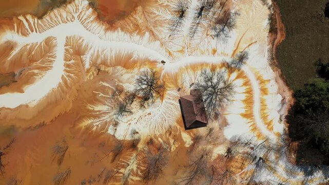 Aerial view of sinking village house in the middle of toxic acid mine drainage decanting pond. Geamana, Rosia Montana, Romania