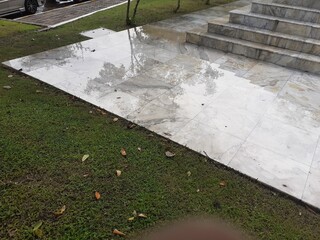 Marble pavement in a wet garden on a rainy day