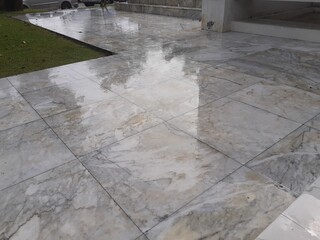 Marble pavement in a wet garden on a rainy day