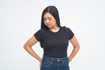 A graceful young Asian woman captured in a half body shot resting her hand on her waist as she looks to the side elegantly. Isolated on a white background.