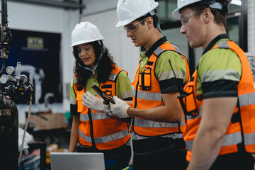 Obraz premium Diverse group of latin engineer working on AI technology in robotics electronics engineering laboratory. Hispanic technician team and colleague research in robot machine futuristic automated control.