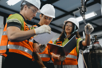 Obraz premium Diverse group of latin engineer working on AI technology in robotics electronics engineering laboratory. Hispanic technician team and colleague research in robot machine futuristic automated control.