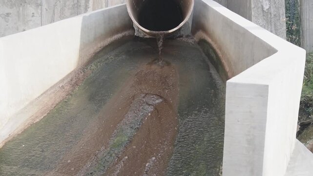 Contaminated wastewater or leachate flowing from a landfill, showing the impact of waste disposal on the environment and water pollution risks.