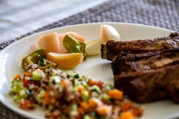 healthy superfood well balanced in nutrients, roasted pork chops, quinoa, salad, vegetables