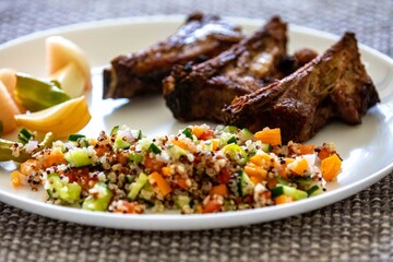 healthy superfood well balanced in nutrients, roasted pork chops, quinoa, salad, vegetables